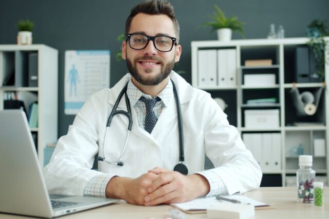 Cabinet de medicină de familie cu birou, stetoscop și dosare medicale pregătite pentru consultații